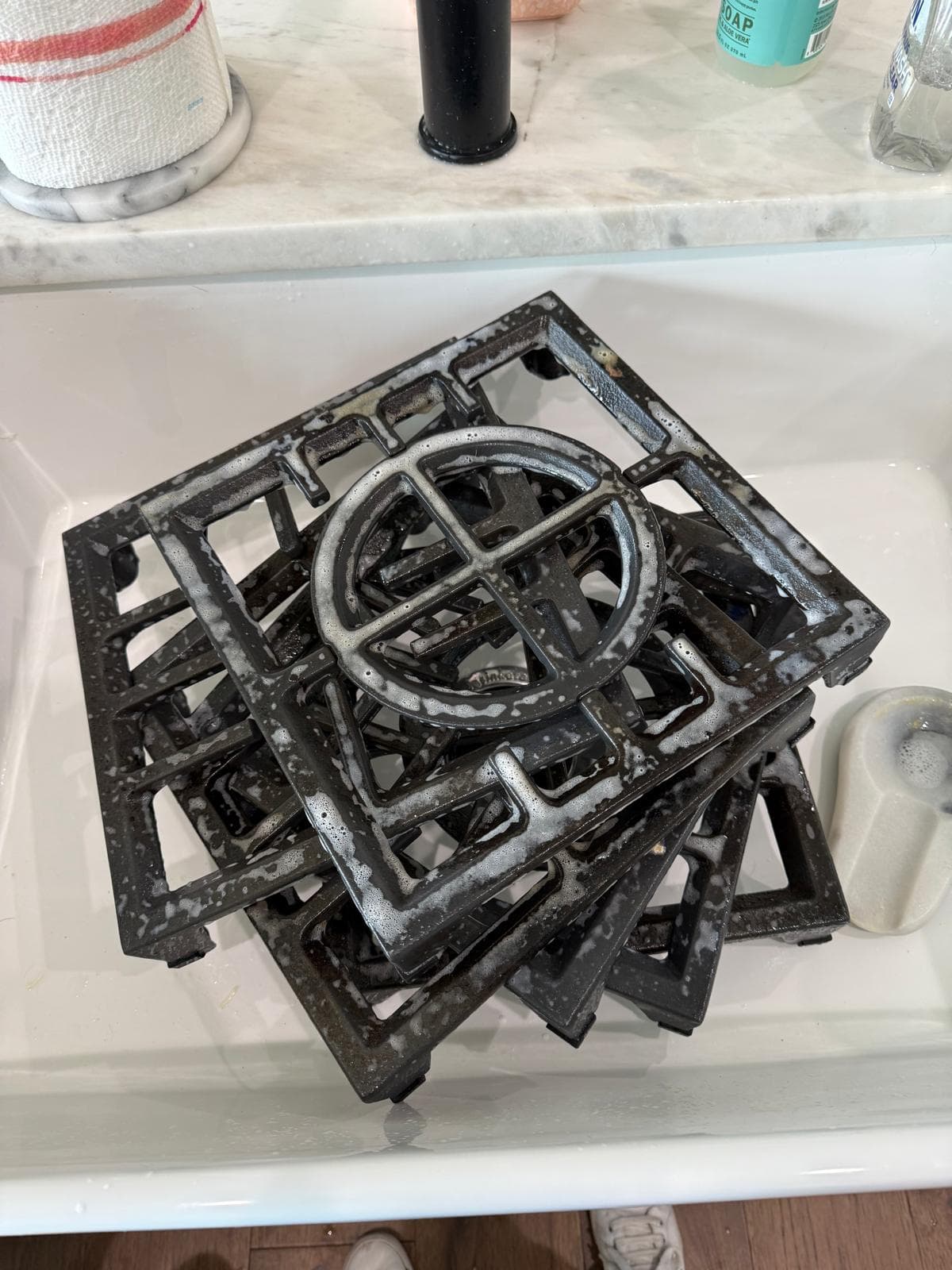 Stove grates soaking during a kitchen deep clean