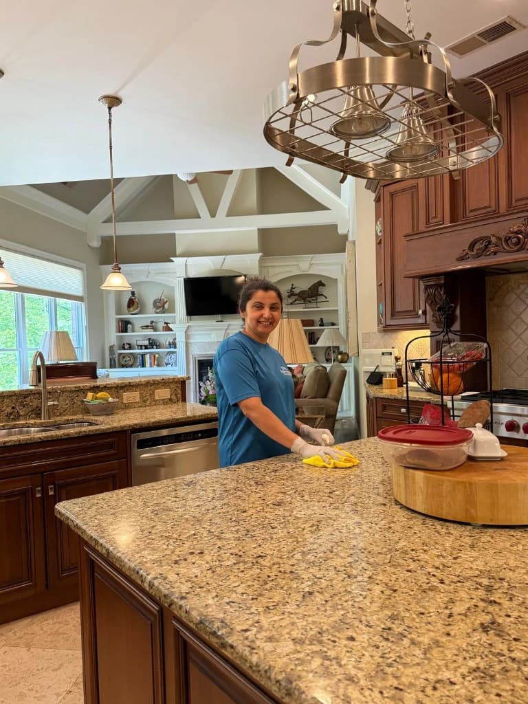 Blue Maids team member cleaning a residential kitchen in Alpharetta
